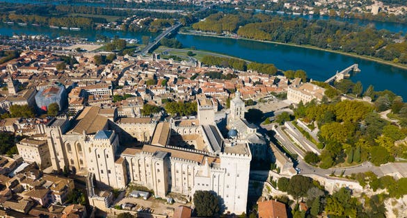 photo of an aerial view of Avignon on bank of Rhone River with Palais des Papes in sunny autumn day, France.
