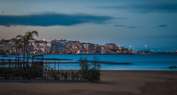 photo of view of The city of Crotone in South Italy, at sunset.