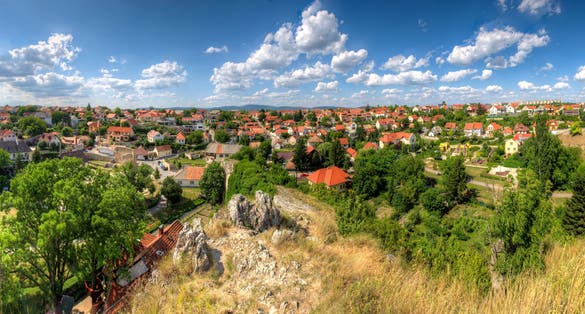 Elevated panoramic view over the outskirts of the Hungarian city of Veszprém near Lake Balaton with terraced houses and detached houses in an upscale residential style