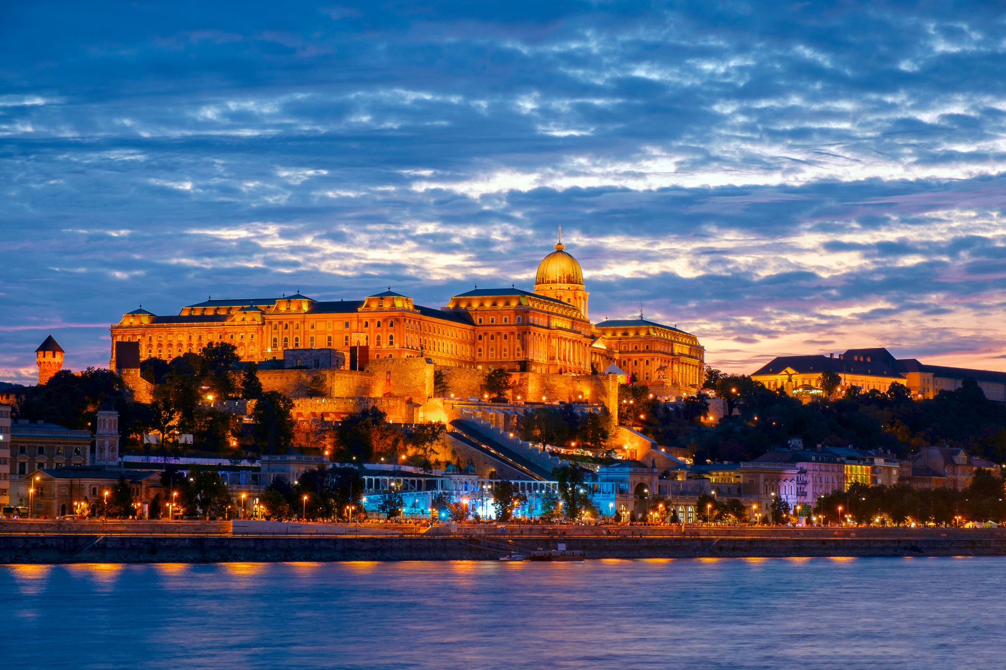 Photo of Illuminated night view of Buda Castle Palatial venue, seen from the banks of river Danube, Budapest, Hungary.