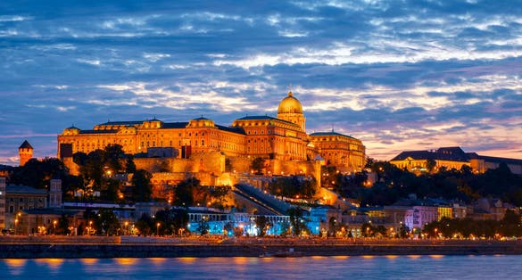 Photo of Illuminated night view of Buda Castle Palatial venue, seen from the banks of river Danube, Budapest, Hungary.