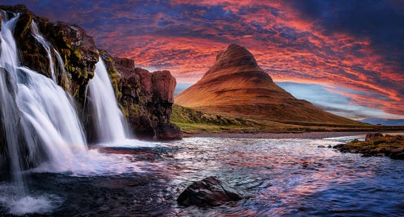 photo of incredible nature landscape of Iceland. Fantastic picturesque sunset over majestic Kirkjufell (Church mountain) and waterfalls. Kirkjufell mountain, Iceland. Famous travel locations.