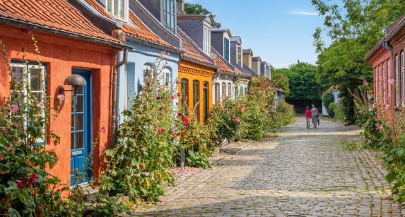 Colourful old cottages on a quiet street in Aarhus, Denmark.