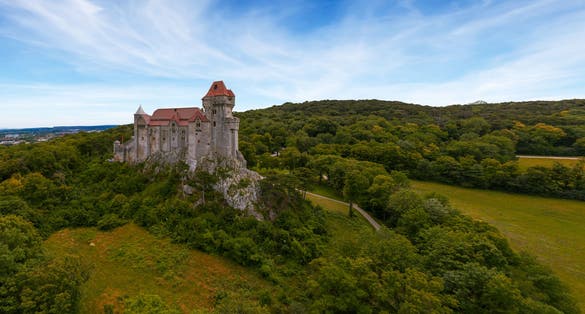 Photo of Liechtenstein Castle from the sky during sunset. The Liechtenstein Castle, situated on the southern edge of the Vienna Woods, Austria. Breathaking view about a medieval castle.