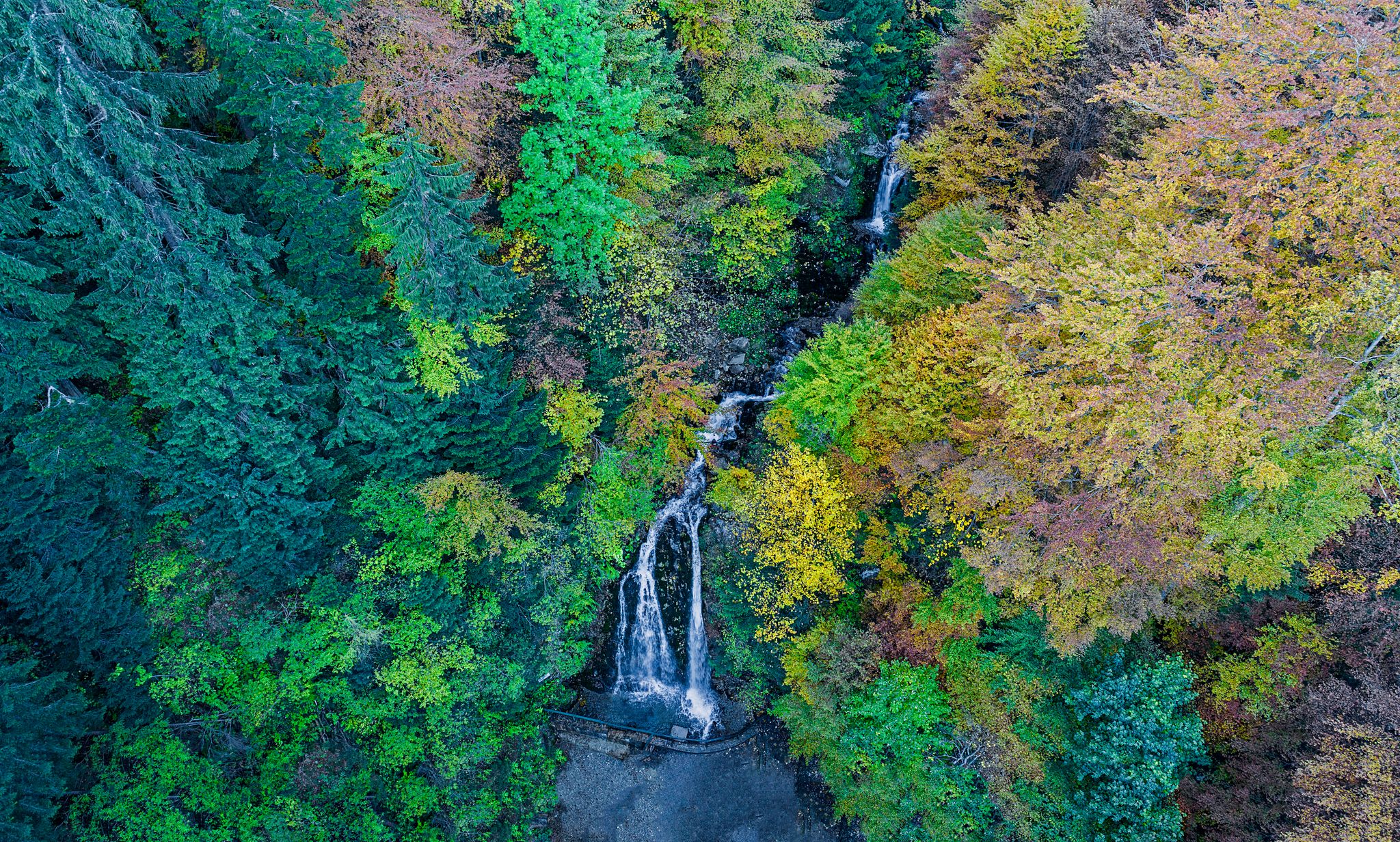 Photo of Cascada Urlatoarea Busteni (Urlatoarea waterfall) Howling in Bucegi mountains, Romania near to Sinaia. Nature wonder in the Carpathian Mountains park.