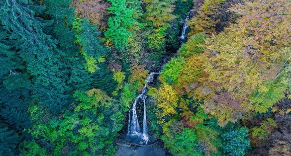 Photo of Cascada Urlatoarea Busteni (Urlatoarea waterfall) Howling in Bucegi mountains, Romania near to Sinaia. Nature wonder in the Carpathian Mountains park.