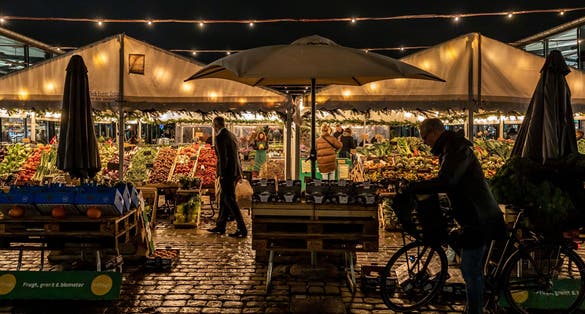 Photo of Torvehallerne outdoor food market at night.