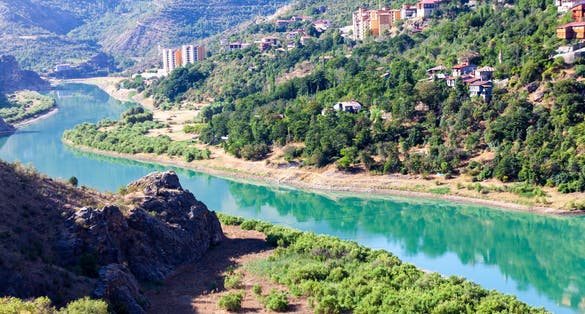 Photo of traditional Erzincan Kemaliye houses, the Dark Canyon and Euphrates River, during the summer season. 
