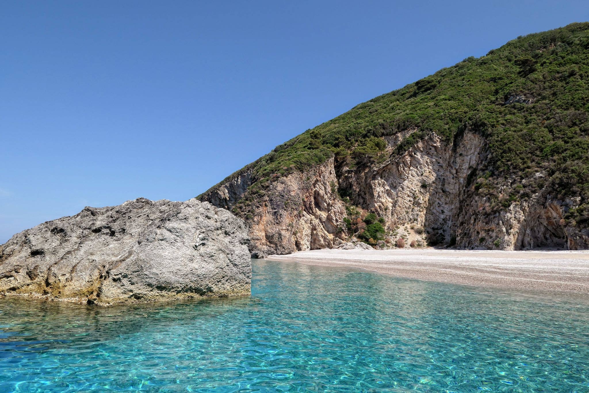 paradise beach of Liapades at Corfu Island (Greece). Sedimentary rock cliff of chalk rocks and crystal clear water.