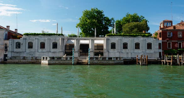 photo of the Grand Canal and the Peggy Guggenheim Collection. Clear blue skies and wonderful water in the canal. Perfect water trip for a tourist venice italy.