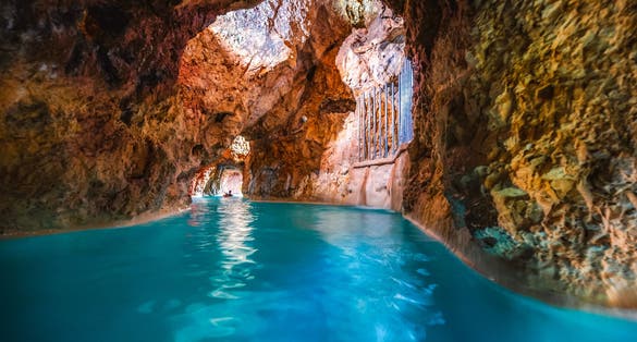 photo of view of Miskolc, Hungary - 3. june. 2022: Tourists enjoy at the cave with thermal water - natural SPA in Hungary at Miskolc Hungary. Rock tube with thermal water