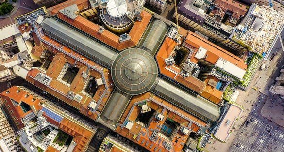 photo of milan, Italy. Gallery of victor emanuel II 1865-1877 year of construction. Roofs of the city aerial view, head over shot.