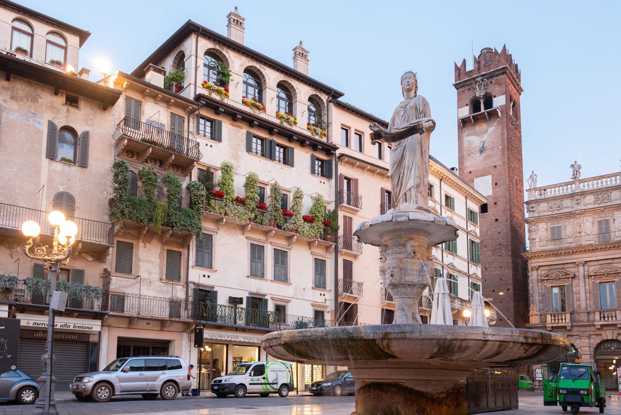 PHOTO OF The western side of the Piazza delle Erbe (Market's square) with the Baroque Palazzo Maffei, a marble column with St. Mark's Lion, symbol of the Republic of Venice.