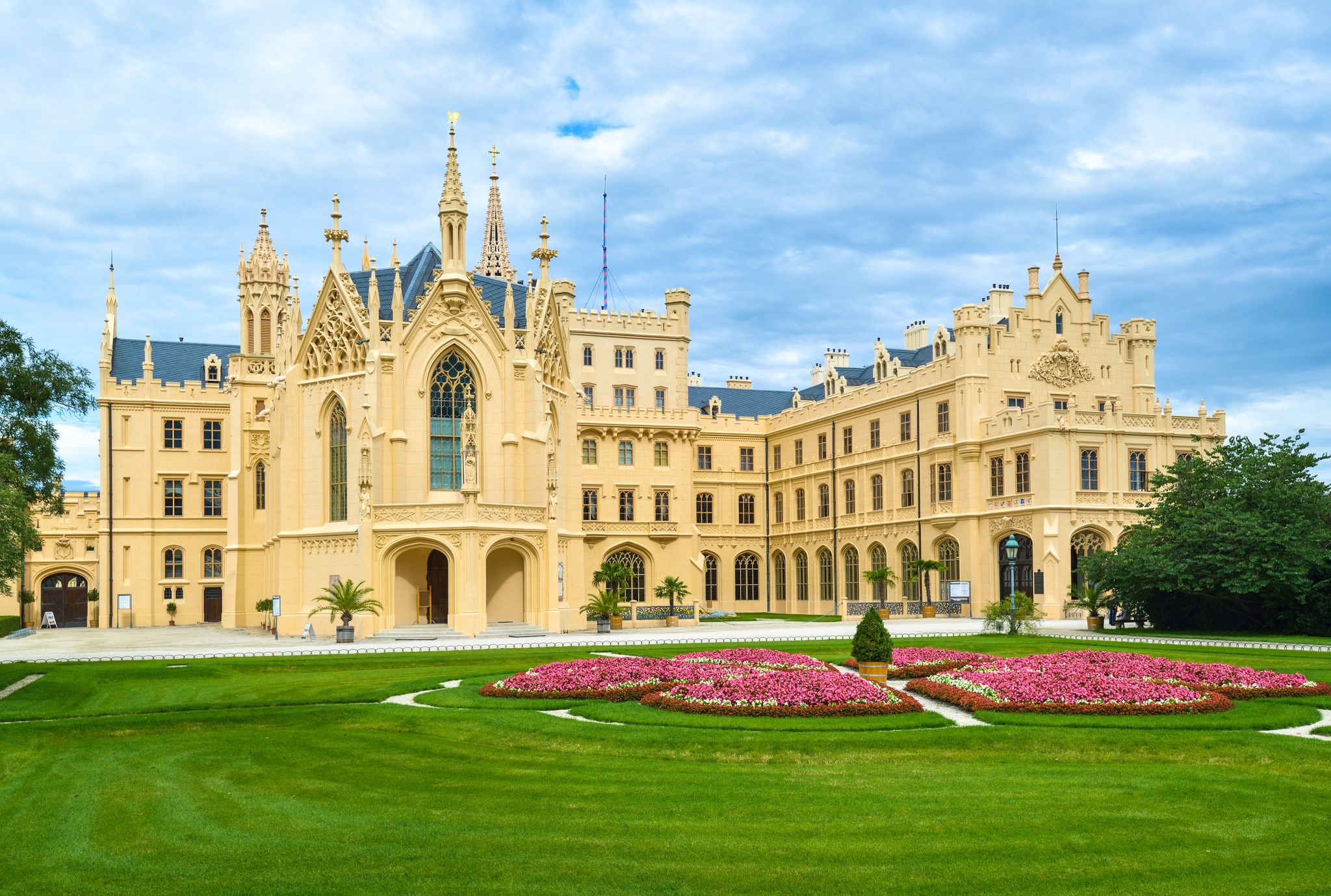 Photo of Lednice Chateau with beautiful gardens and parks on a sunny summer day, Czech Republic.