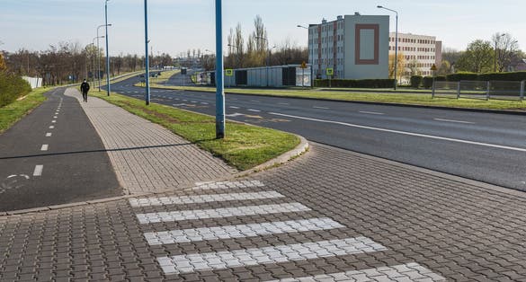 photo of view of Empty street and one pedestrian due to Coronavirus Covid-19 pandemic in Lubin, Poland.