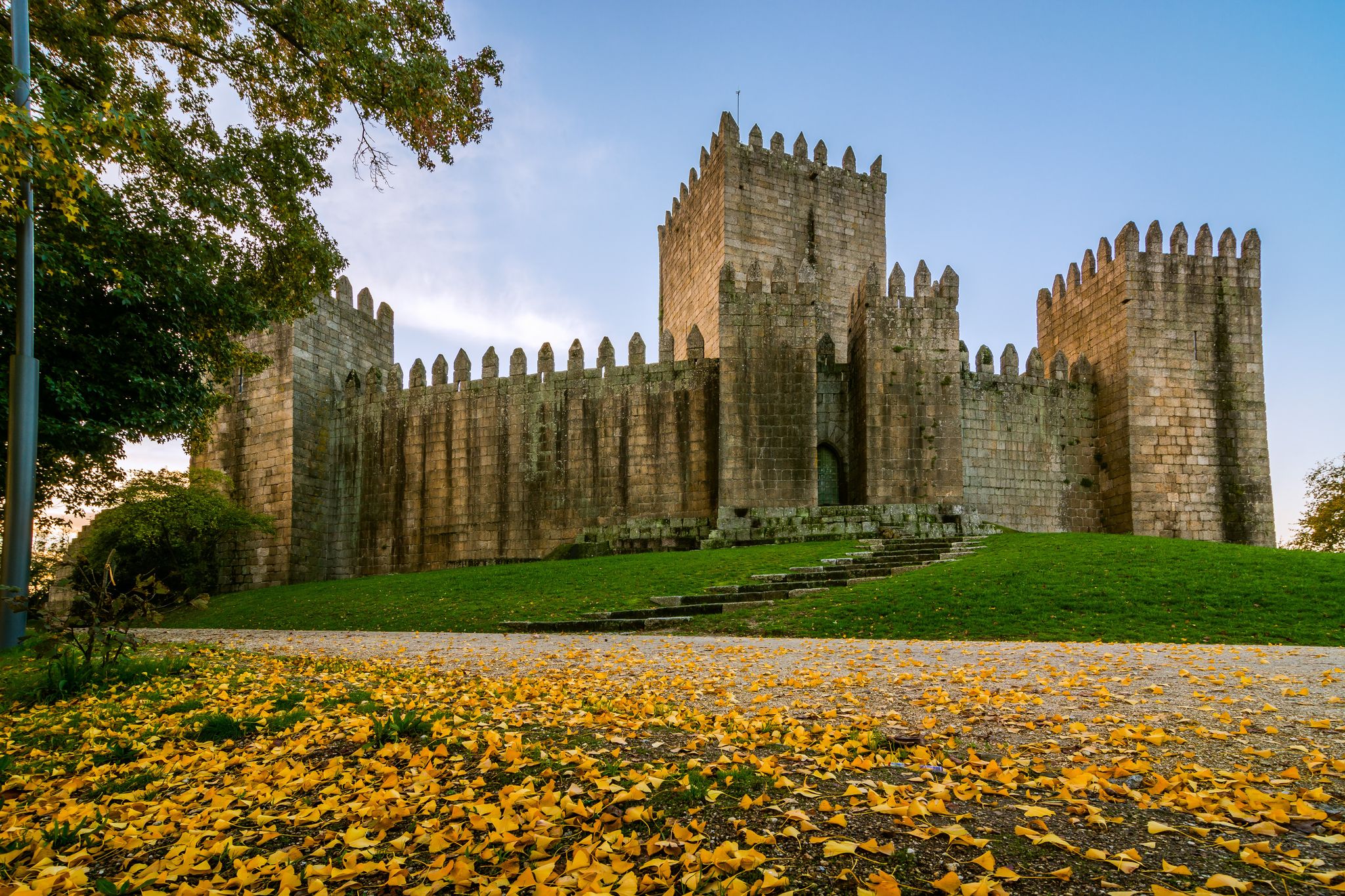 Photo of Guimaraes, Portugal - November 23 , 2014 : End of a sunny day in the autumn next to the castle of Guimaraes.