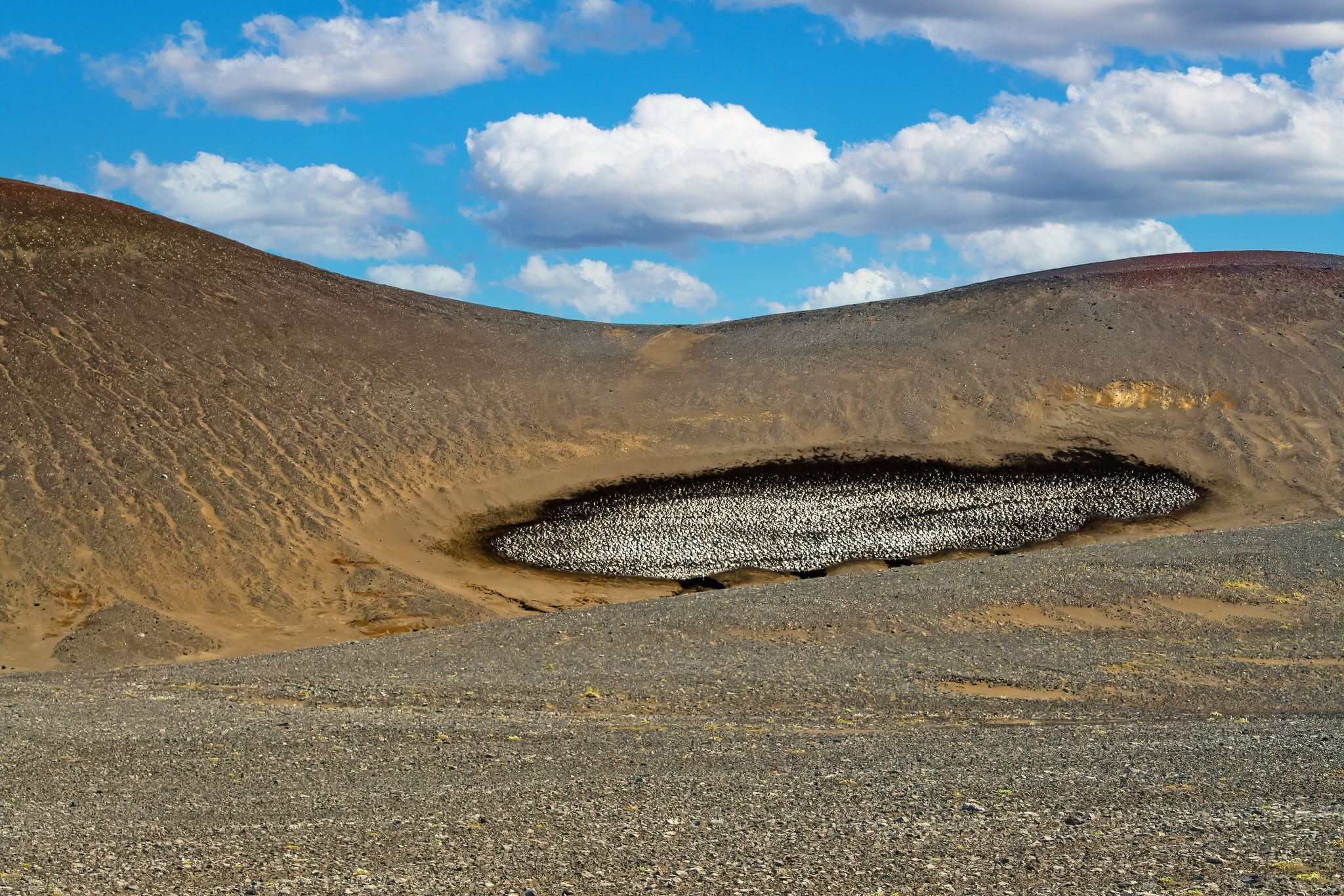 photo of Barren dry volcanic hill with stain dirty ice rest - Grábrók Area, Iceland Highlands .