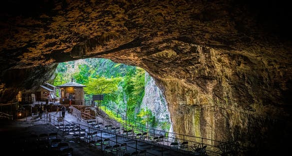 Photo of the entrance of Peak Cavern, also known as the Devil's Arse, in Castleton, Derbyshire, England, UK.
