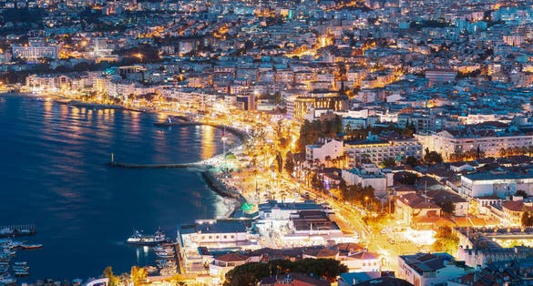Kusadasi, Aydin Province, Turkey. Waterfront And Kusadasi Cityscape In Summer Evening.
