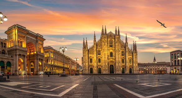 photo of view of Duomo square and Milan Cathedral at sunrise, Italy.