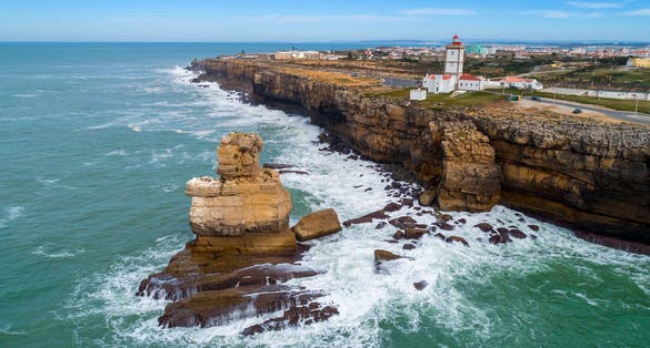 Aerial view of lighthouse on Cabo Carvoeiro and Atlantic ocean in Portugal