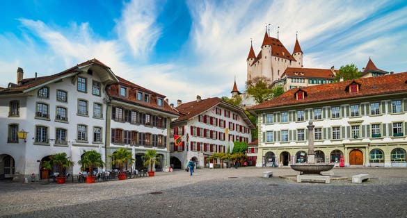 Photo of Amazing view of City Hall square and castle of Thun, Switzerland under picturesque sky. Thun city is a popular travel destination and tourist attraction in Switzerland.