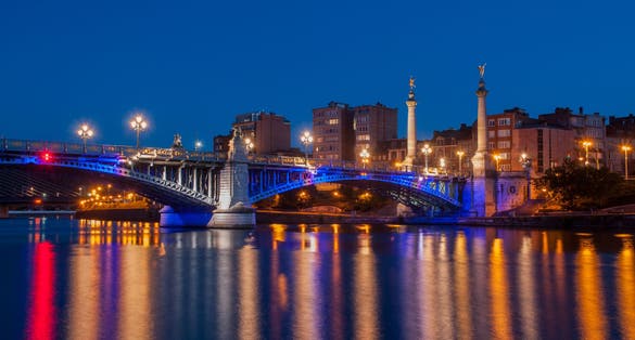Fragnee Bridge over the river Meuse in Liège, Wallonia, Belgium, during the evening blue hour.