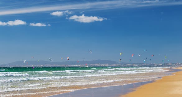 Photo of Kiteboarding on the Atlantic ocean beach at Fonte da Telha beach, Costa da Caparica, Portugal.