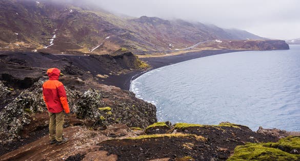 PHOTO OF Tourist looking at black beach of Lake Kleifarvatn near Krysuvik-Seltun in Iceland, top view .