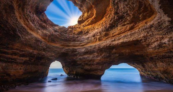 Photo of Scenic view of Benagil Cave with tranquil waters. Lagoa, Portugal.