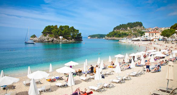 Photo of beautiful city sand beach on Ionian Sea in Parga, Greece.