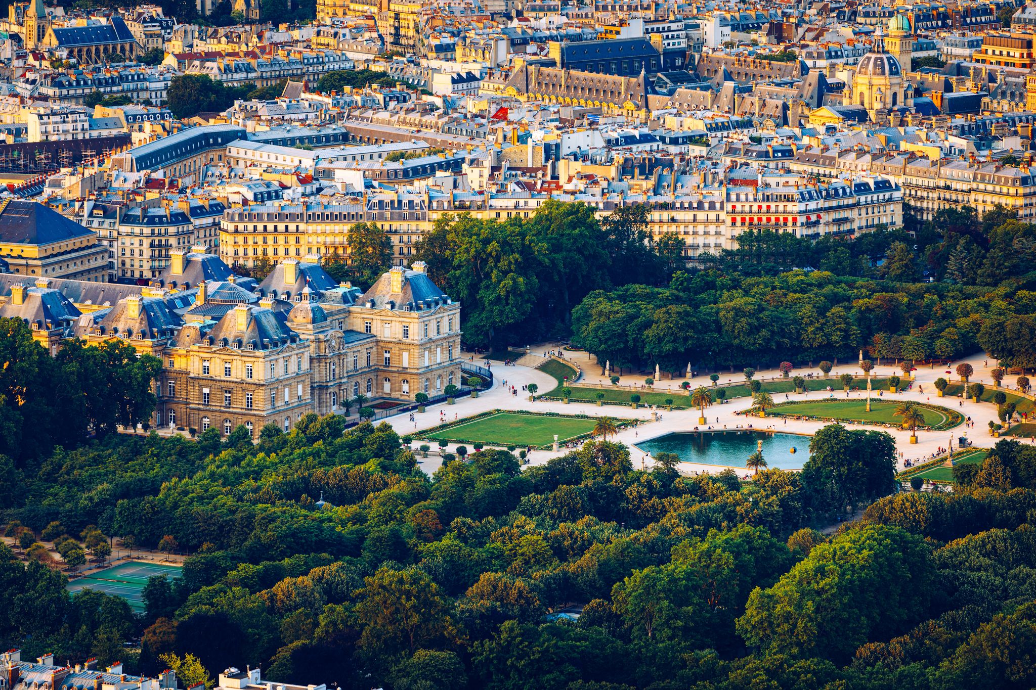photo of an aerial view of the Luxembourg Palace in The Jardin du Luxembourg or Luxembourg Gardens view on the main facade and water pond in Paris, France.