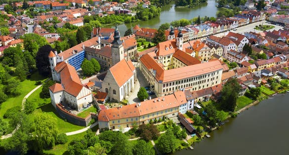 Photo of aerial view of Telc Castle and city reflected in lake, Czech Republic.