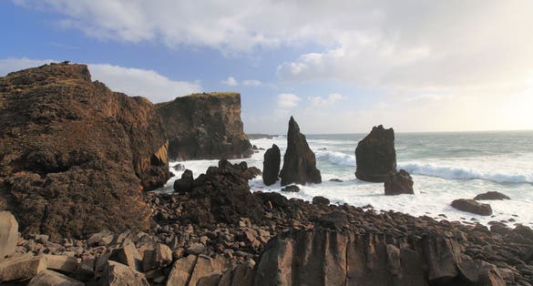 photo of view of Cliffs at the Dyrhólaey Peninsula, Iceland on the tip of Iceland's southern coast, Southern Peninsula, Iceland.