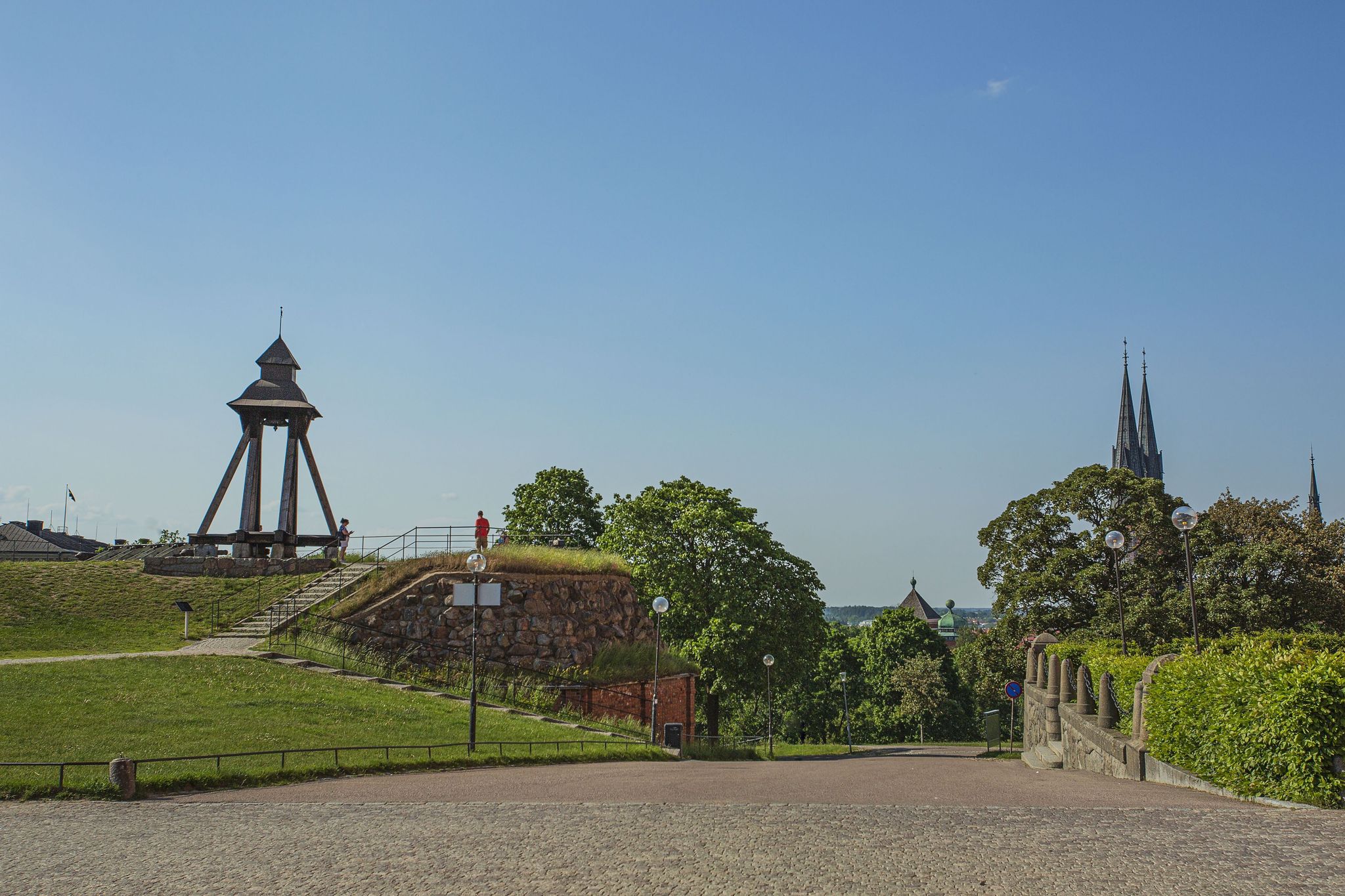 photo of Gunillaklockan in beautiful park near the Uppsala Castle with Green trees on blue sky background in Uppsala, Sweden.