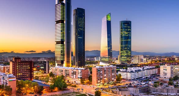 Photo of Madrid, Spain financial district skyline at twilight.