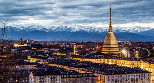 photo of Turin, sunset over the city with Mole Antonelliana and alps