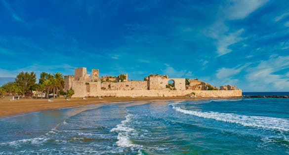 Photo of historical Ancient Kizkalesi, Kiz Kalesi or Maiden's Castle with Korykos Ruins in Mersin Beach from Turkey.