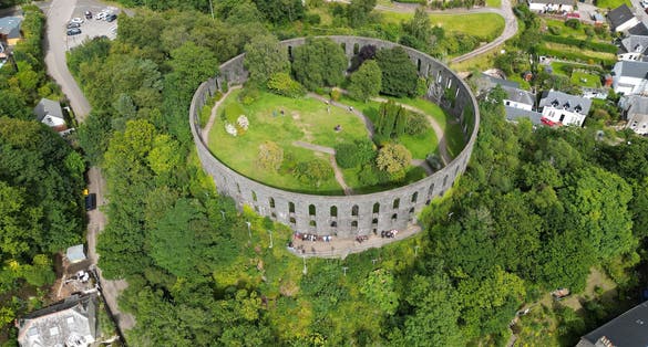 photo of view of An aerial view of McCaig's Tower and Battery Hill, located in Oban, Scotland.