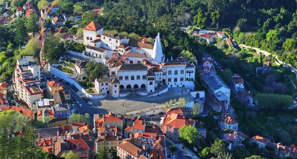 Photo of aerial view of Palace of Sintra (Palacio Nacional de Sintra) in Sintra in a beautiful summer day, Portugal.