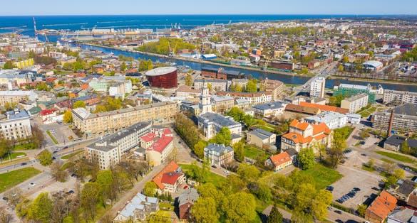 photo of view of Liepaja,Latvia,Baltics.Beautiful panoramic aerial view photo from flying drone to Holy Trinity Cathedral,Concert hall Great Amber (Lielais dzintars) and city center, trade channel in spring. (Series)