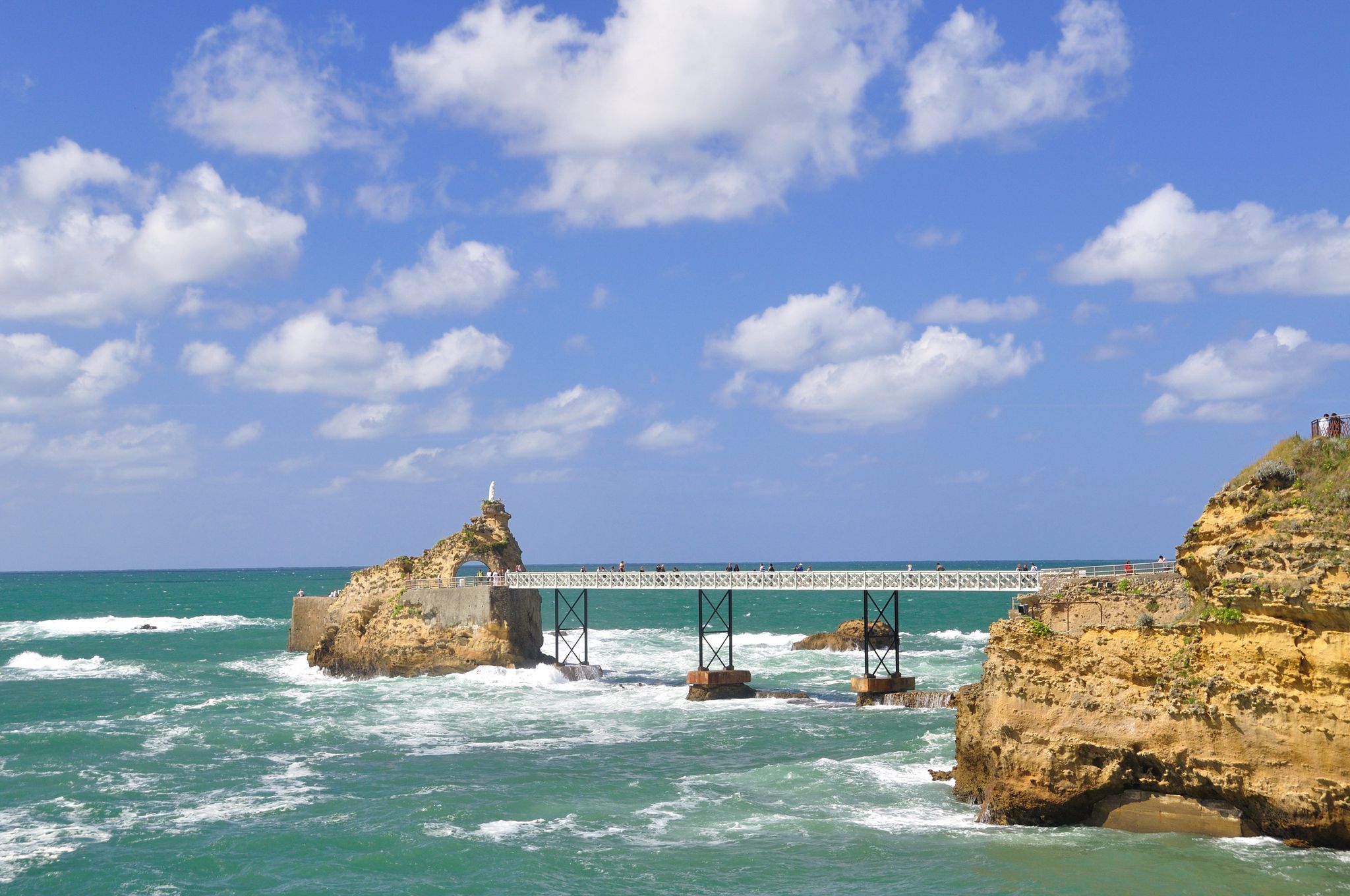 photo of the famous Rocher de la Vierge it's a rock of the Virgin Mary at beautiful morning in Biarritz, France.