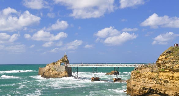 photo of the famous Rocher de la Vierge it's a rock of the Virgin Mary at beautiful morning in Biarritz, France.