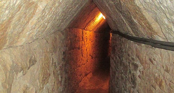 photo of view Reinforced section of the tunnel, with pointed roof and polygonal masonry walls, Nea Poli, Greece.