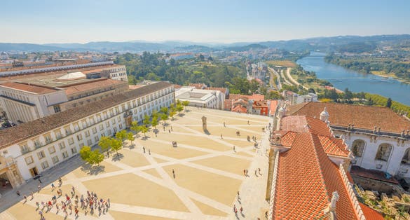 Coimbra uptown aerial view from top of bell clock tower. Coimbra University courtyard and Mondego river on background. Coimbra in Central Portugal, is famous for its University, the oldest in Europe.