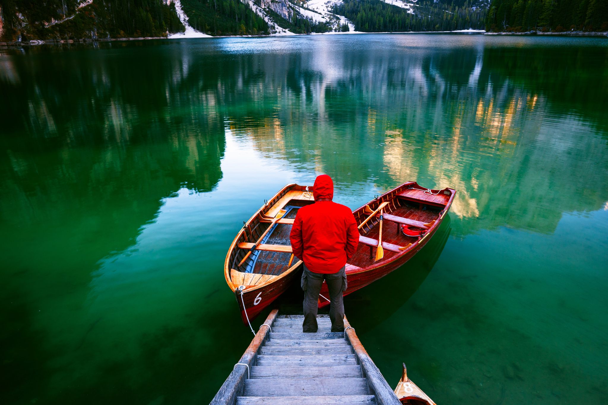 photo of Man alone at the Braies Lake ( Pragser Wildsee ) in Dolomites mountains, Sudtirol, Italy,Prags - Braies Italy.