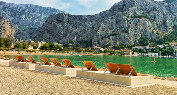 Photo of sunbeds on the beach in Omis, Croatia.
