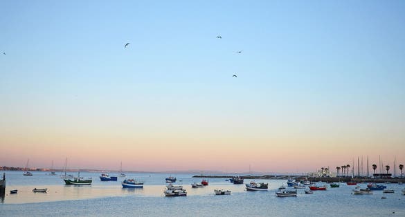 Photo of Sunset colours and fishing boats in Cascais, Portugal.
