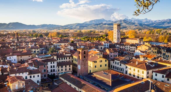 photo of view of  Panoramic view of Lucca medieval town with typical terracotta tiled roofs and narrow streets, Tuscany, Italy