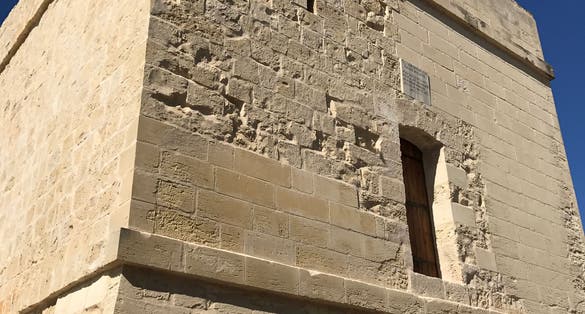 Stone watch tower fortification in St Julian’s Malta, erected in 1658 by grandmaster FR Martin De Redin the tower has been subtly renovated over the years which can be seen in the stone work